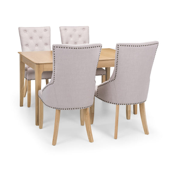 Dining table set with four gray upholstered chairs on a white background