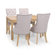 Dining table set with four gray upholstered chairs on a white background