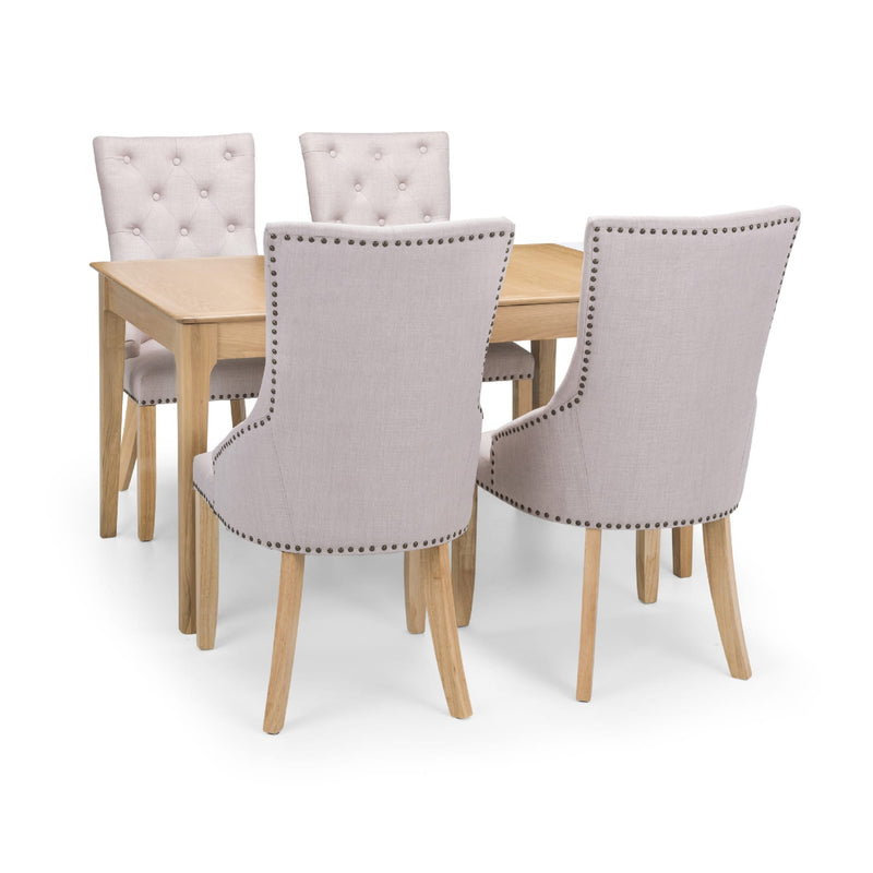 Dining table set with four gray upholstered chairs on a white background
