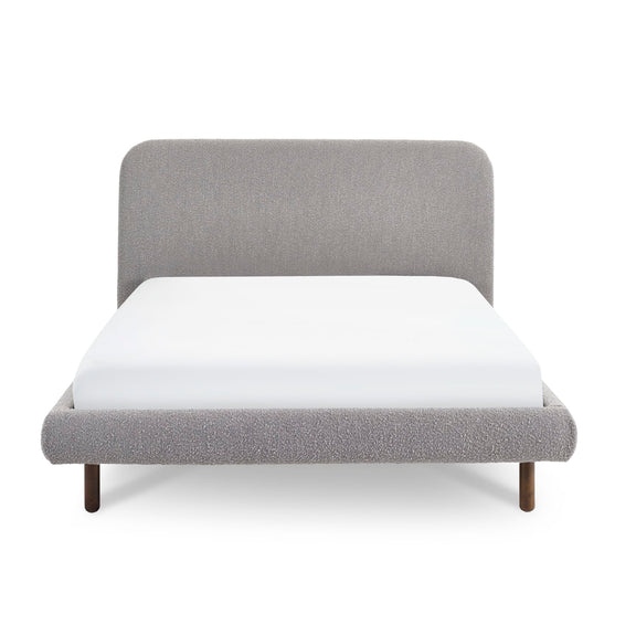 Gray upholstered bed with white mattress on a white background