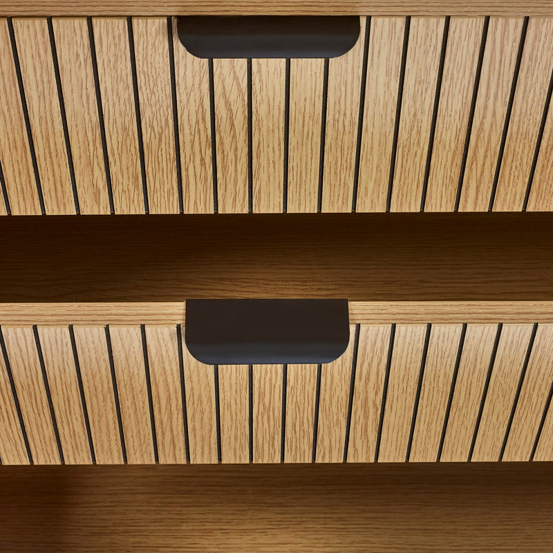Wooden drawer with black handles on a wooden cabinet