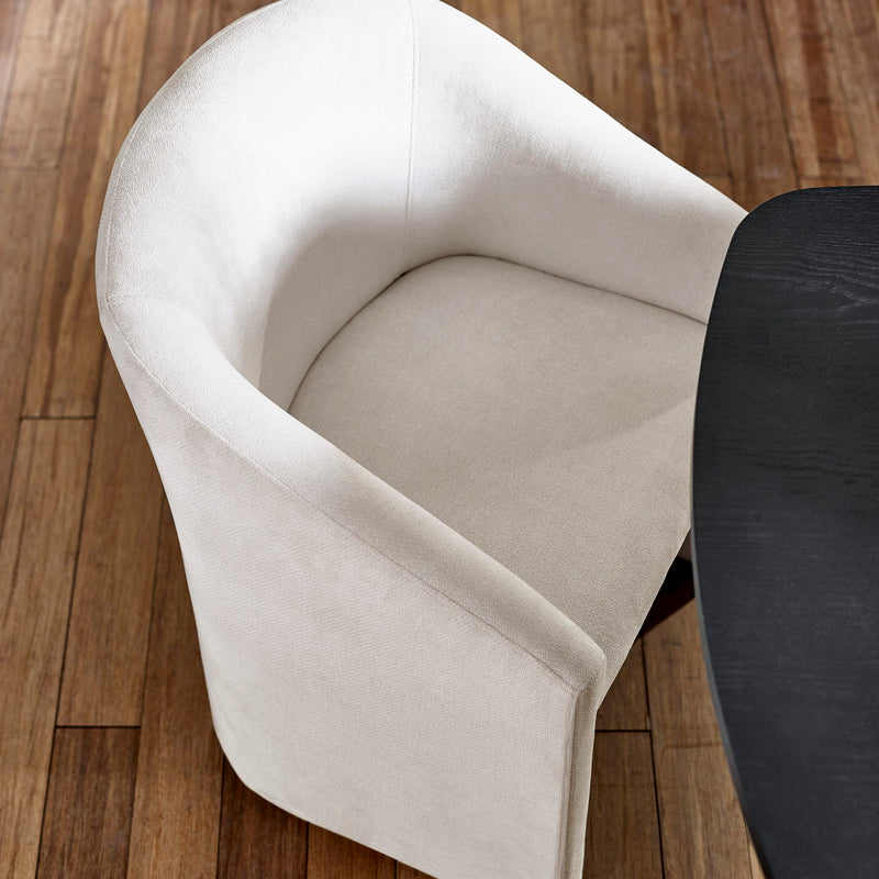 White chair with a black seat on a wooden floor