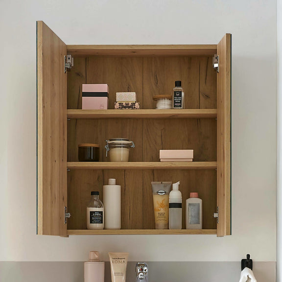 Wooden cabinet with shelves containing various toiletries on a neutral background