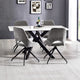 Dining table with four chairs in a modern room with gray walls and a window.