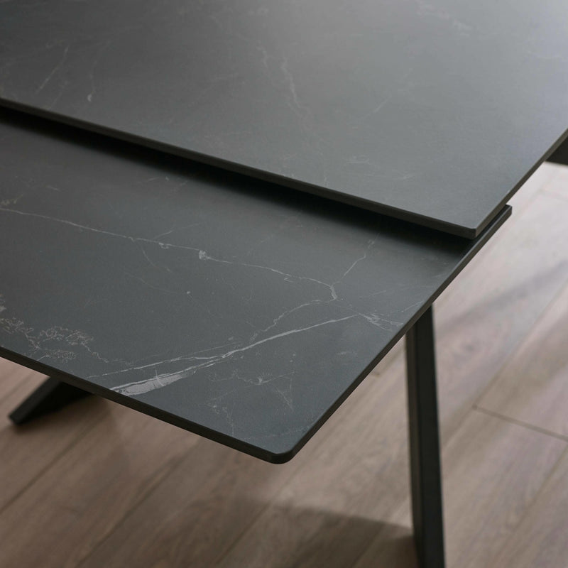 Close-up of a black marble-patterned table on a wooden floor