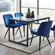 Dining table with four blue chairs in a modern room with large windows.