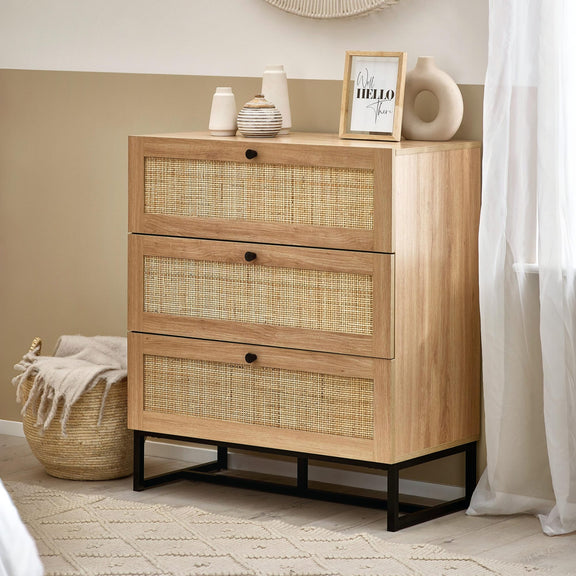 Wooden dresser with wicker drawers in a room setting