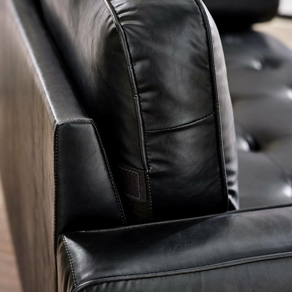 Close-up of a black leather chair with visible stitching