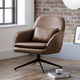 Brown armchair in a room with a brick wall and window.