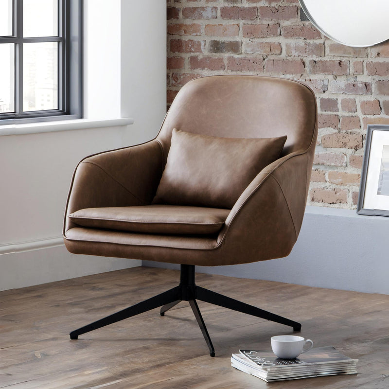 Brown armchair in a room with a brick wall and window.