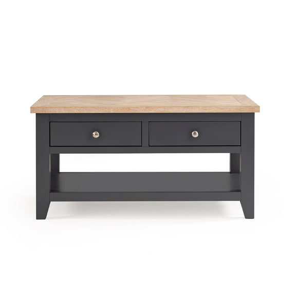 Dark gray coffee table with two drawers and a light wood top on a white background