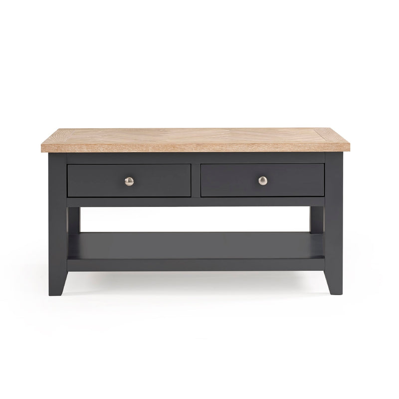 Dark gray coffee table with two drawers and a light wood top on a white background