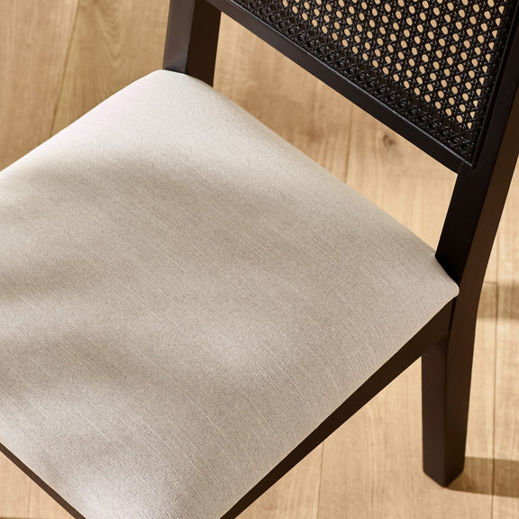 Chair with a beige cushion on a wooden floor