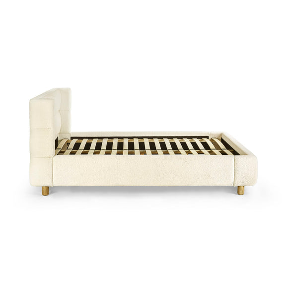 Beige upholstered bed frame on a white background