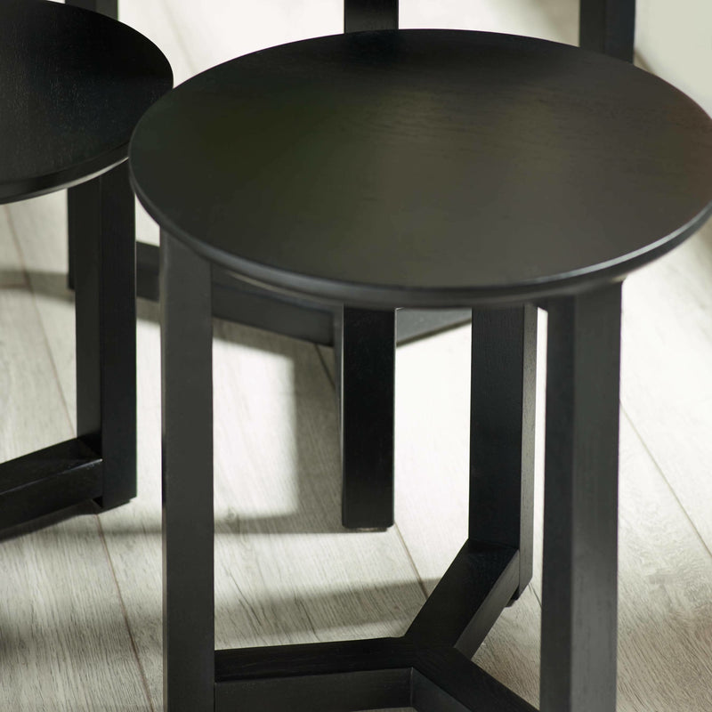Black round table on a wooden floor