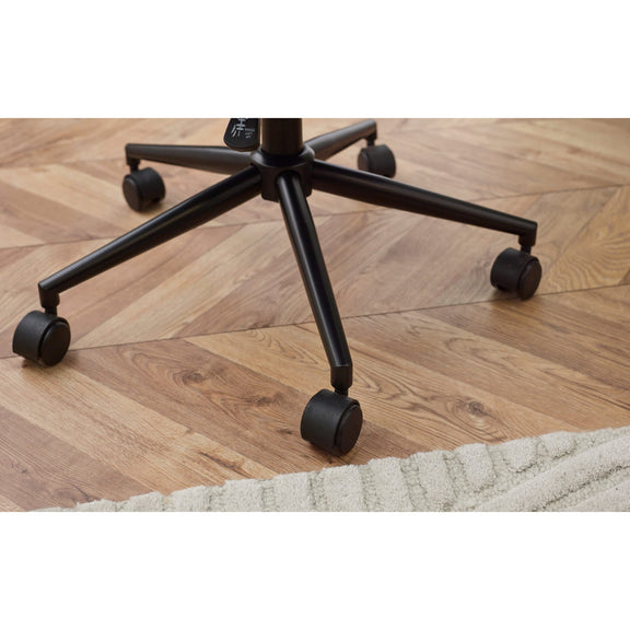 Black office chair with wheels on a wooden floor