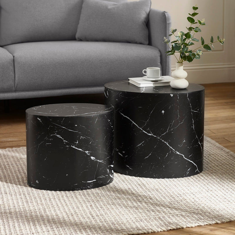 Black marble side tables in a living room setting with a gray sofa and decorative items.