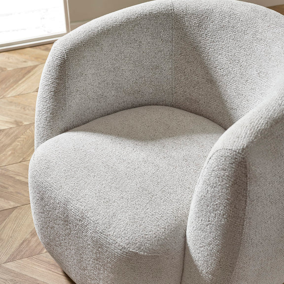 Gray textured armchair on a wooden floor