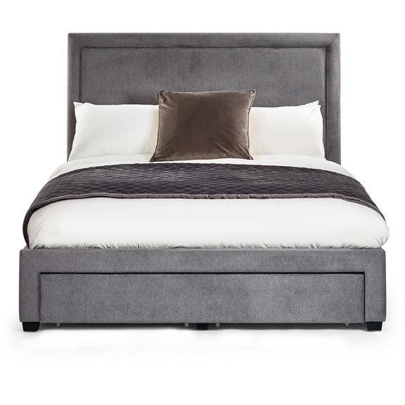 Gray upholstered bed with white bedding and brown throw blanket on a white background