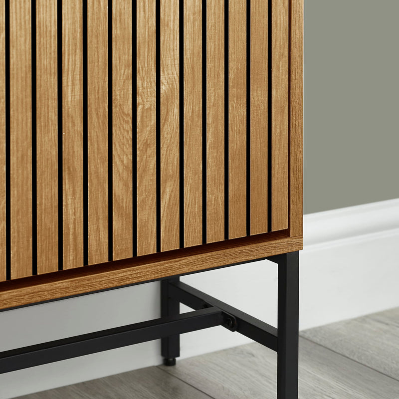 Wooden cabinet with slatted design and black metal legs on a neutral background