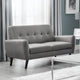 Gray sofa in a living room setting with curtains and a coffee table.