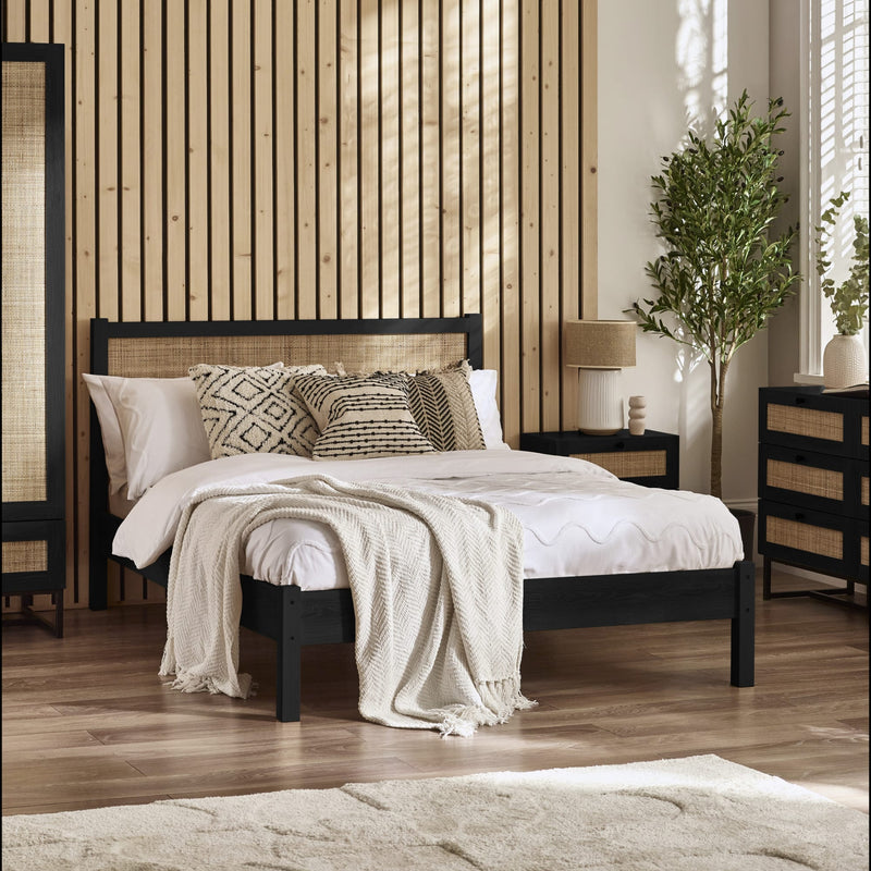 Bedroom with wooden headboard, pillows, and decor elements.