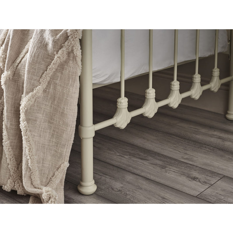 Close-up of a metal bed frame with wooden flooring