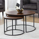 Set of two wooden coffee tables with metal legs in a living room setting.