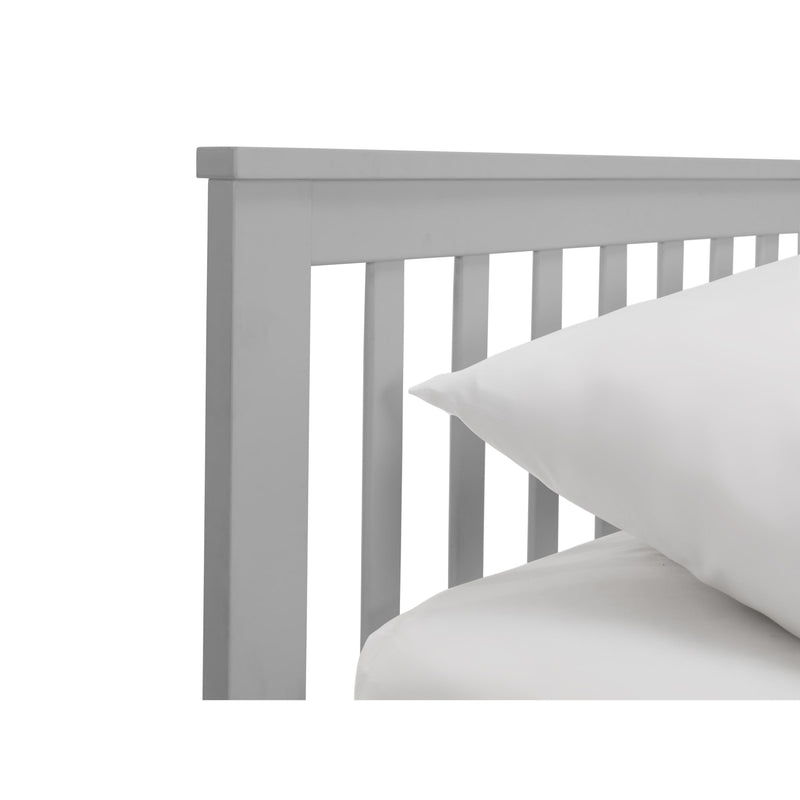 Gray wooden headboard with white pillows on a white background