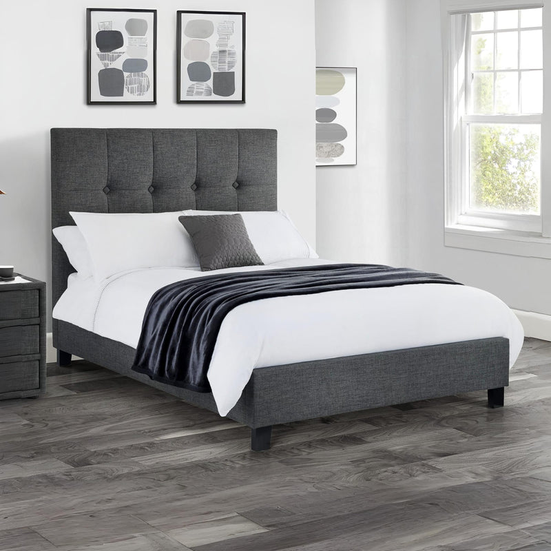 Gray upholstered bed with white bedding in a bedroom setting.
