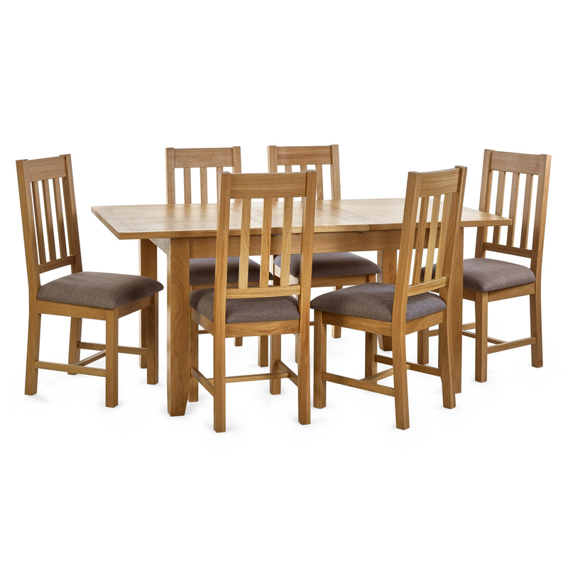 Wooden dining table with six matching chairs on a white background