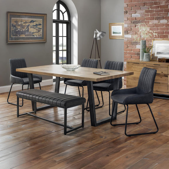 Dining room with wooden table and gray chairs on a wooden floor.