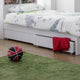 Children's bedroom with a bed, basketball, and green rug.