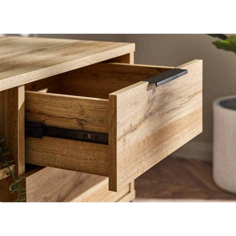 Wooden drawer being pulled out on a wooden cabinet with a blurred background