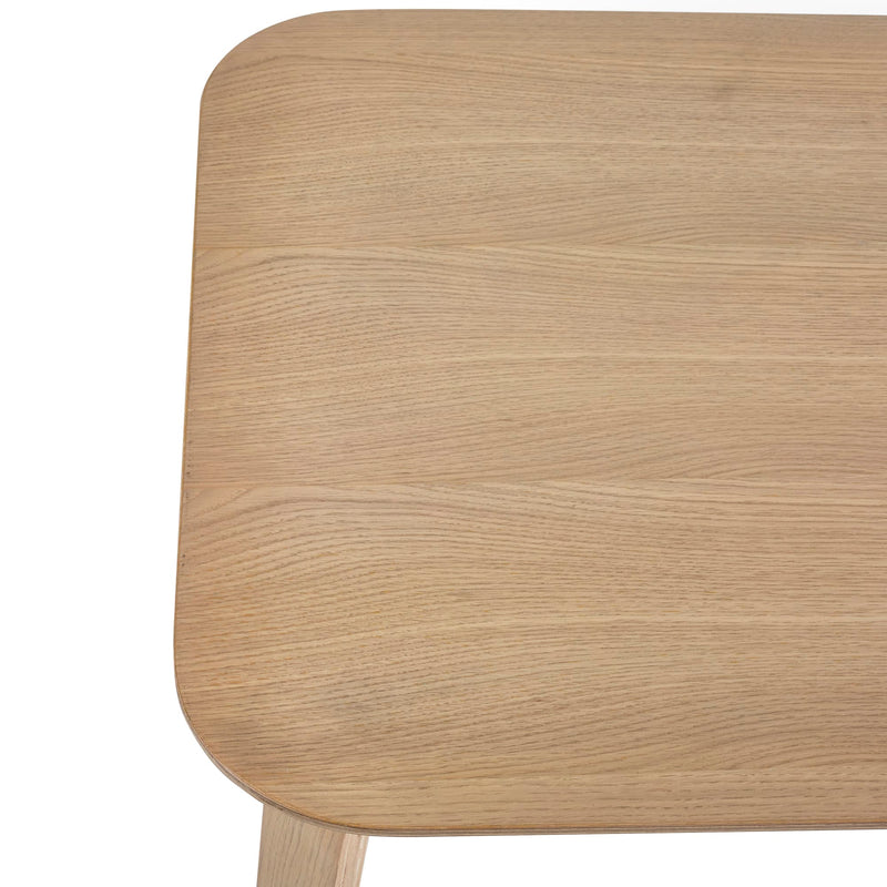Close-up of a wooden surface with a light brown color and visible grain pattern.