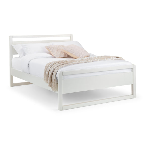 White bed frame with bedding on a white background