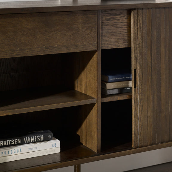 Wooden cabinet with open door revealing books inside, on a dark background