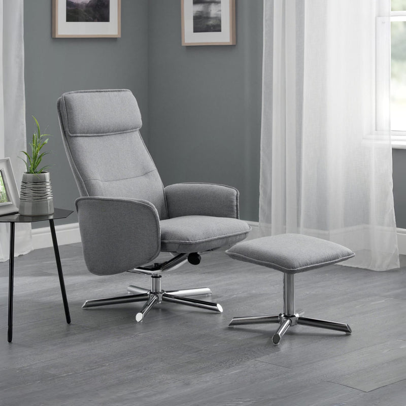 Gray recliner chair with ottoman in a room with gray walls and white curtains.
