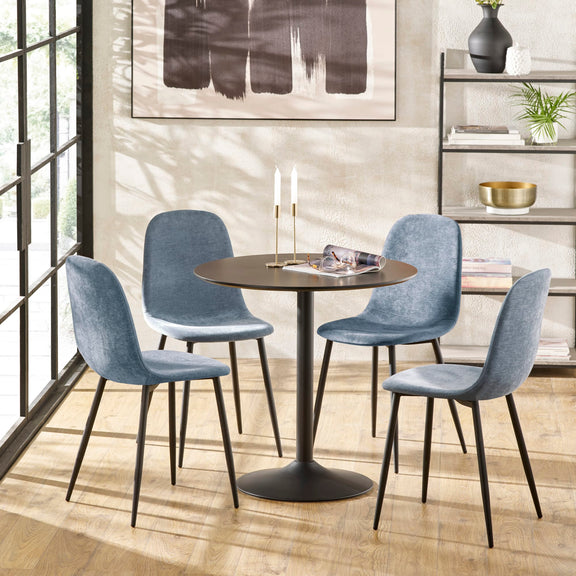 Dining room with a round table and four blue chairs, featuring a modern abstract painting on the wall.