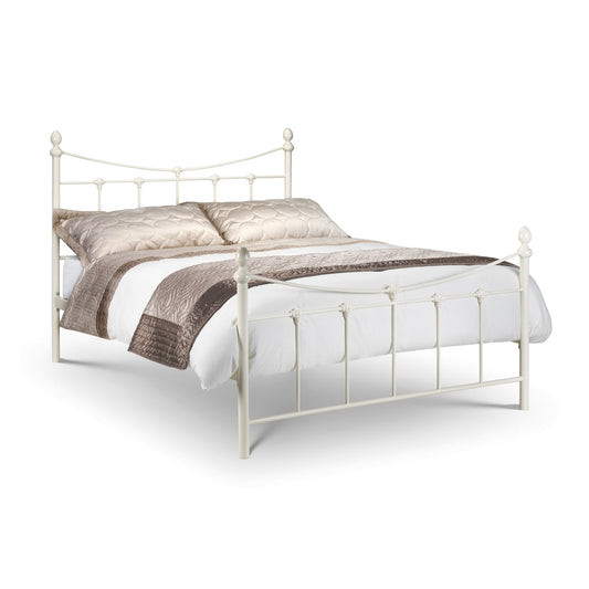White metal bed with bedding on a white background
