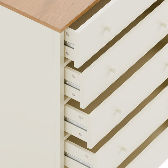 Close-up of a white drawer unit with wooden top