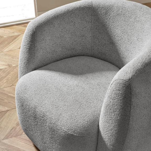 Gray textured armchair on a wooden floor