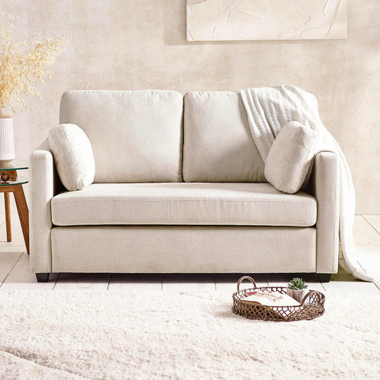 Beige sofa in a living room setting with a neutral color palette.