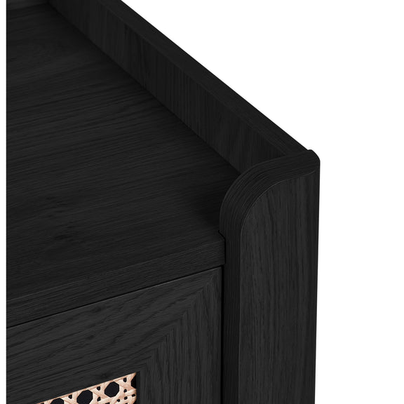 Close-up of black wood frame and woven rattan drawer front