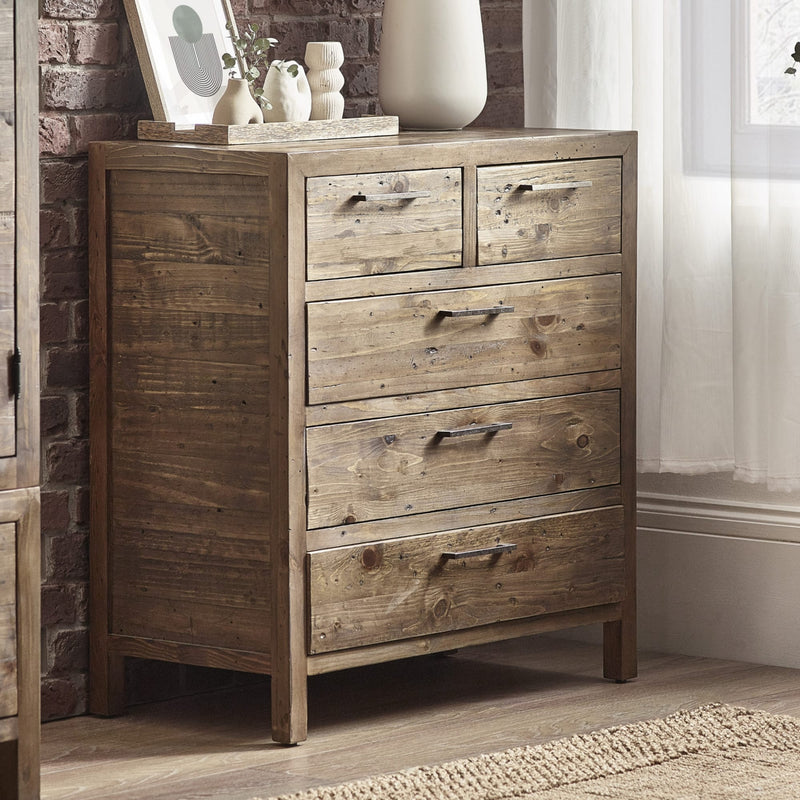 Wooden dresser with four drawers in a room setting.