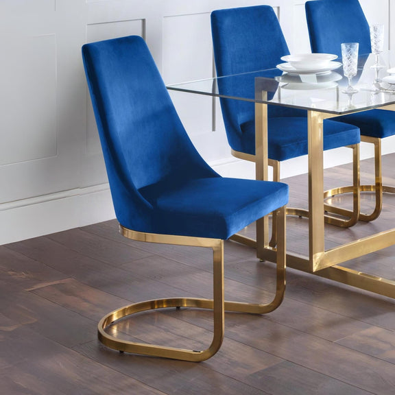 Blue chairs with gold legs around a glass dining table.