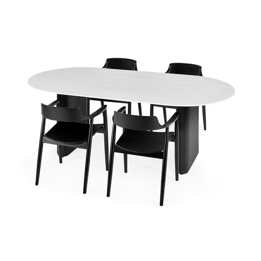 White oval dining table with four black chairs on a white background