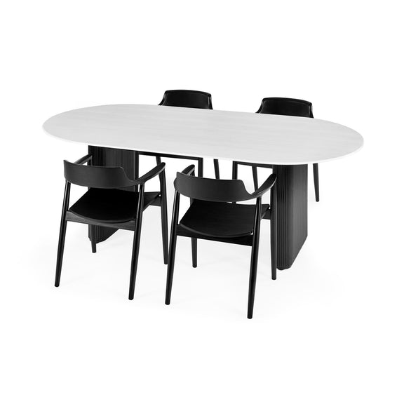 White oval dining table with four black chairs on a white background