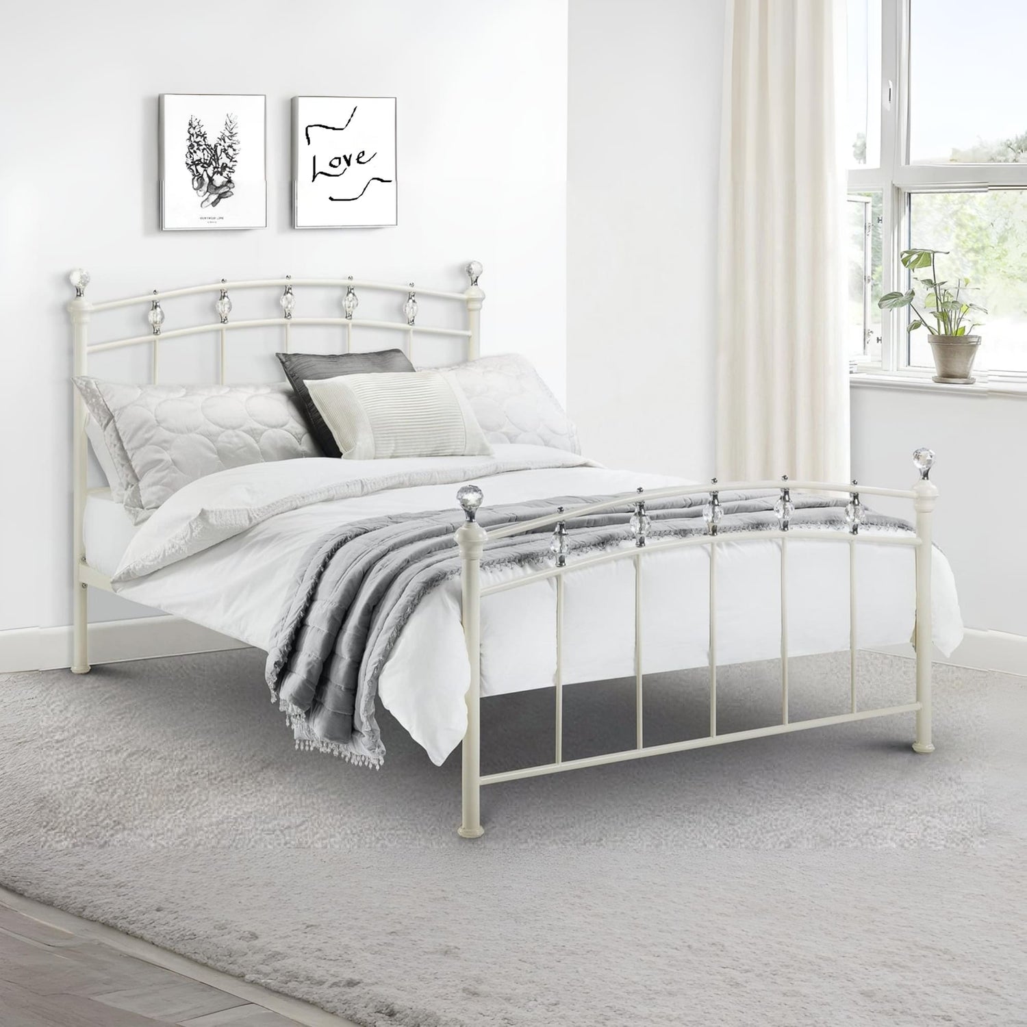 White metal bed with bedding in a bright bedroom