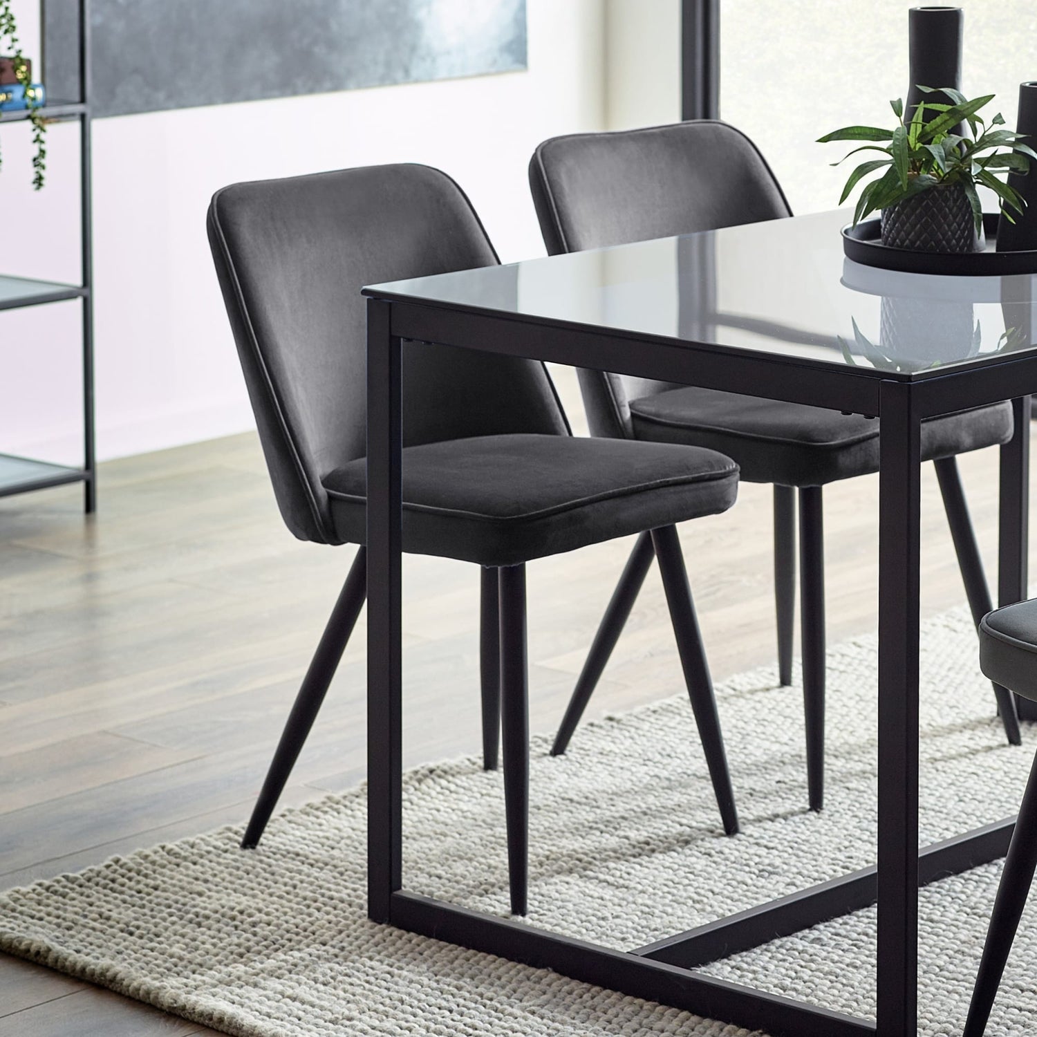 Dining table with black chairs in a modern room setting